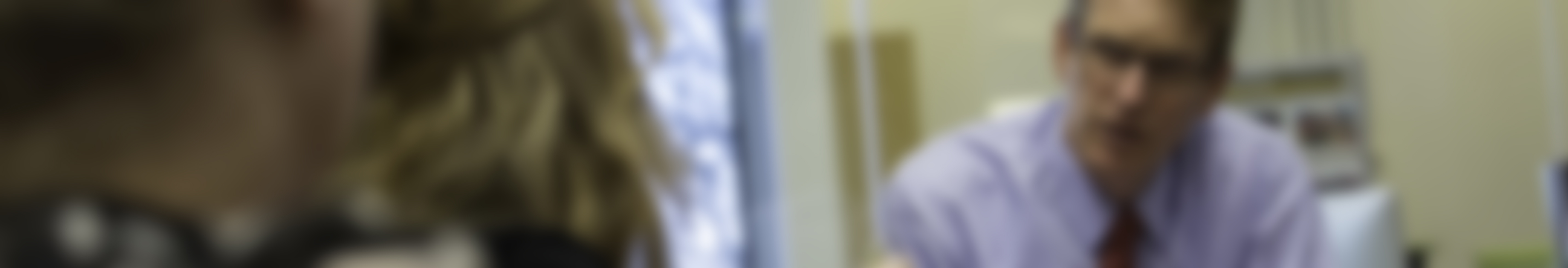 Out of focus image of three people talking